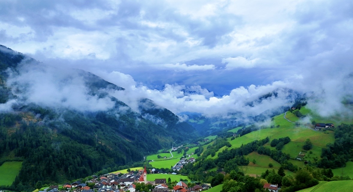 Misty mountain valley and village photographed from above